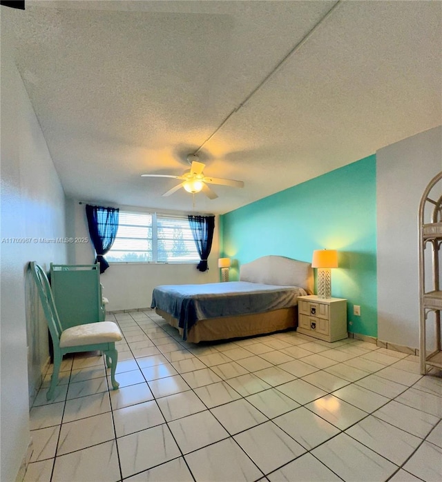 tiled bedroom with a textured ceiling and ceiling fan