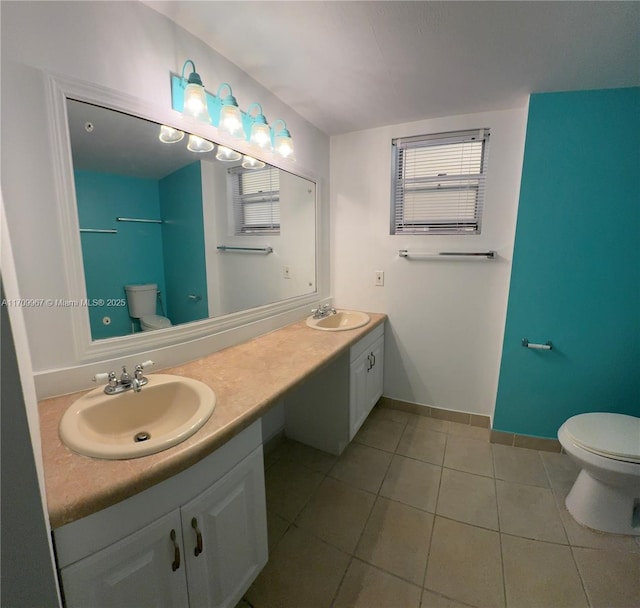 bathroom with tile patterned floors, vanity, and toilet