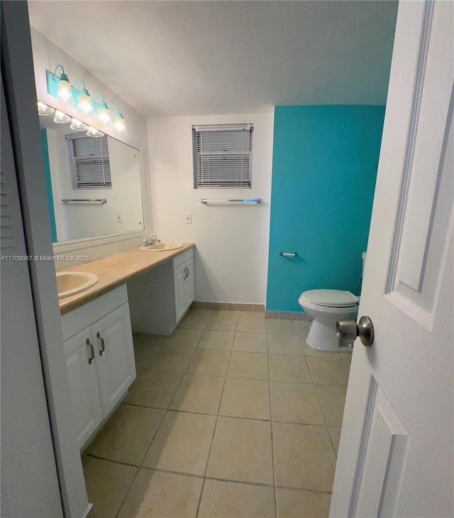 bathroom with tile patterned flooring, vanity, and toilet