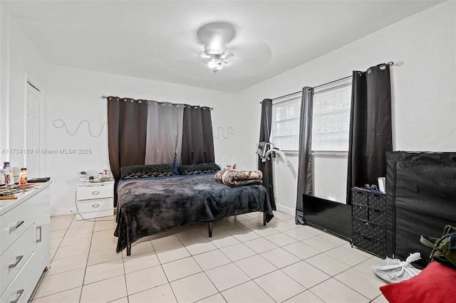 tiled bedroom with ceiling fan