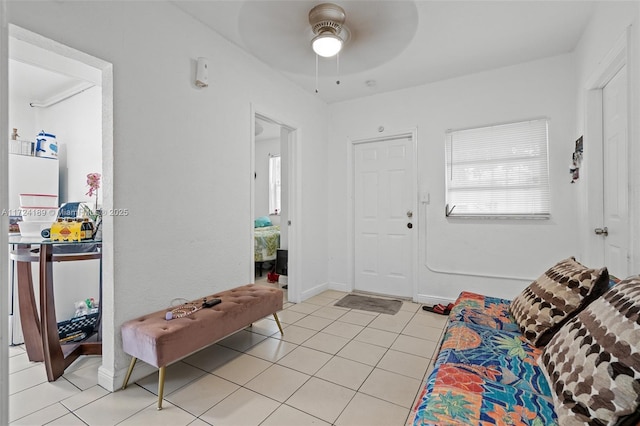 living room featuring light tile patterned flooring and ceiling fan