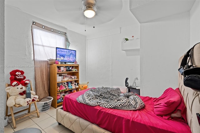 bedroom with ceiling fan and light tile patterned floors