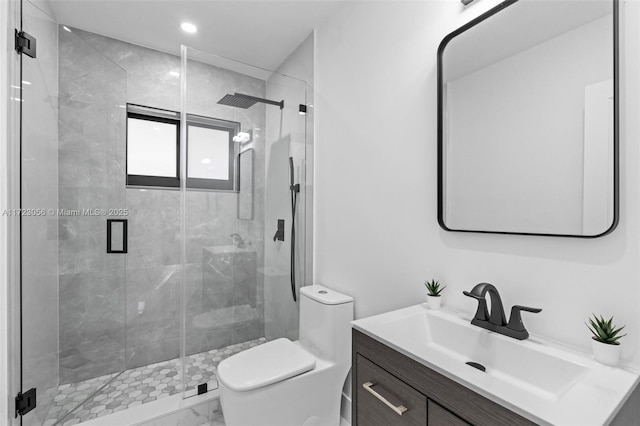 bathroom featuring vanity, toilet, and an enclosed shower