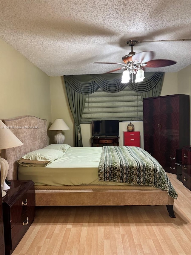 bedroom with a textured ceiling and ceiling fan