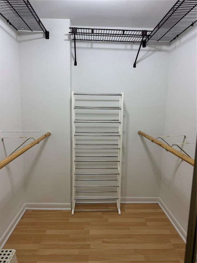 spacious closet featuring hardwood / wood-style floors