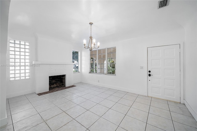 unfurnished living room with light tile patterned floors and a chandelier