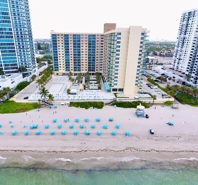 birds eye view of property with a view of the beach and a water view