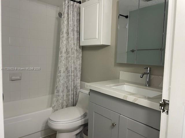 full bathroom featuring vanity, toilet, and shower / bath combo with shower curtain