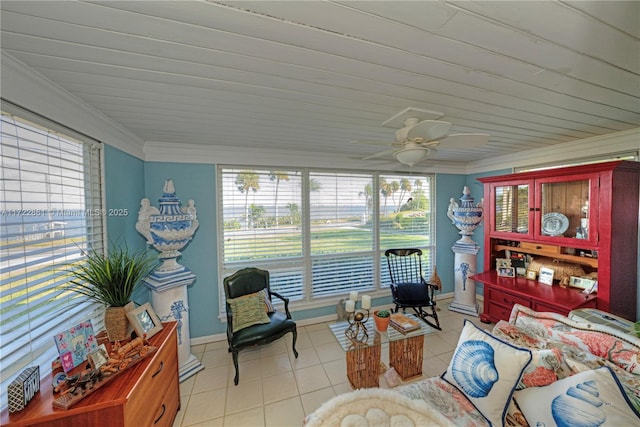 living room with ceiling fan, light tile patterned flooring, and ornamental molding