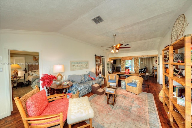 living room with hardwood / wood-style floors, ceiling fan, a textured ceiling, vaulted ceiling, and ornamental molding