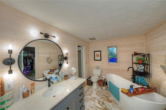 bathroom featuring a tub to relax in, toilet, and wooden walls