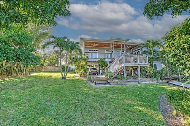 back of house featuring covered porch and a yard