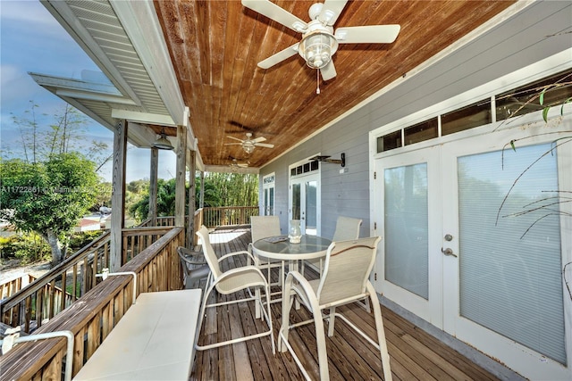 wooden terrace with ceiling fan and french doors