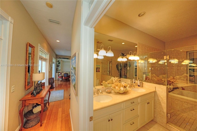 bathroom with vanity, wood-type flooring, and an enclosed shower