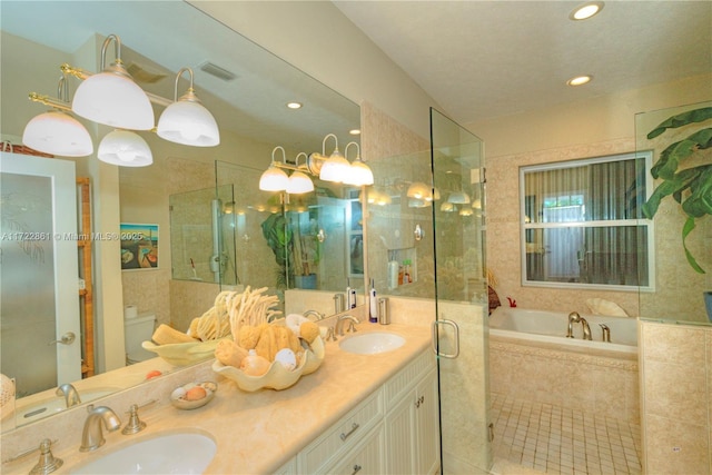 bathroom with vanity and independent shower and bath