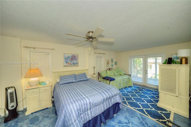 bedroom featuring ceiling fan, access to exterior, a textured ceiling, and french doors