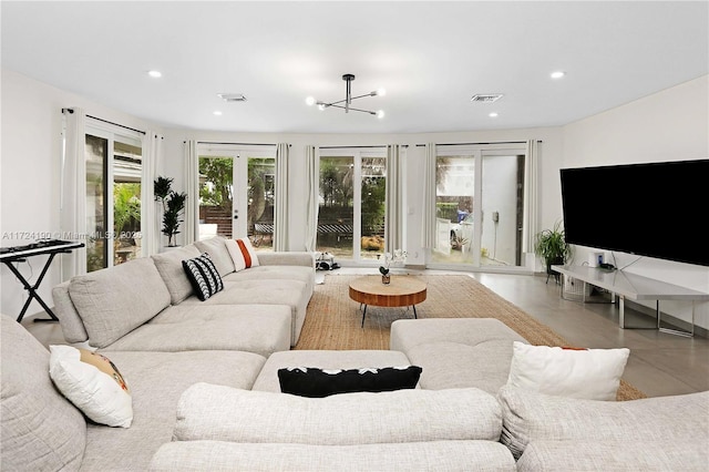 living room with french doors and a notable chandelier