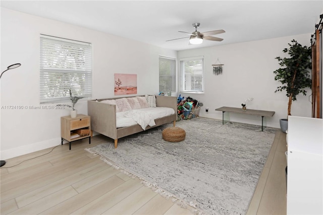 living room with ceiling fan and light wood-type flooring