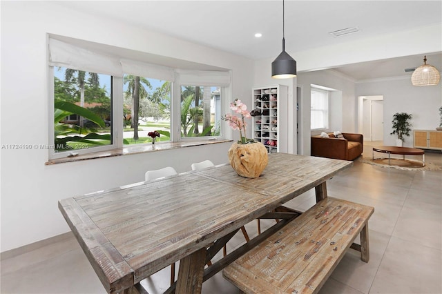 tiled dining room with ornamental molding