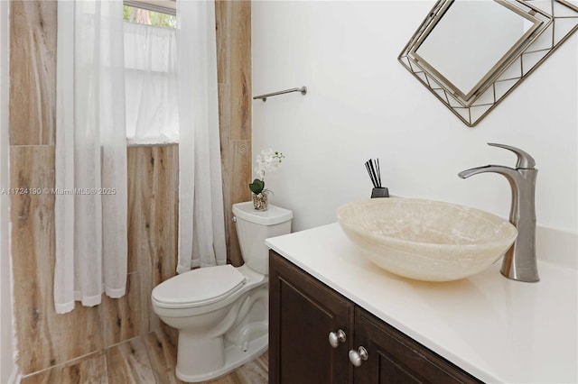 bathroom featuring vanity, toilet, and hardwood / wood-style floors