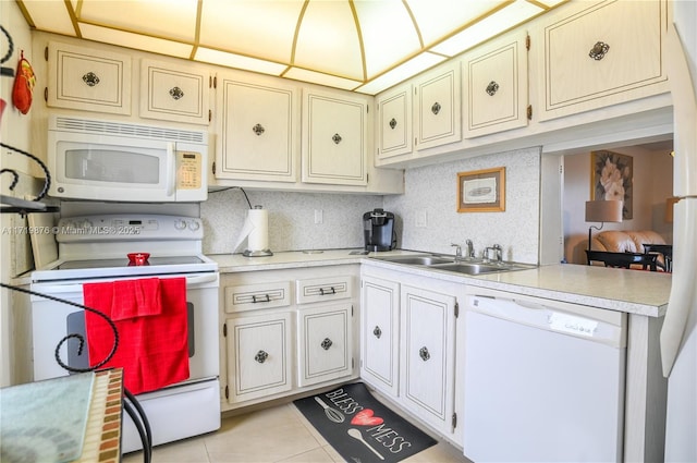 kitchen with kitchen peninsula, backsplash, white appliances, sink, and light tile patterned flooring