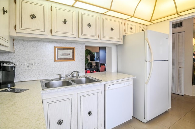 kitchen featuring backsplash, white appliances, sink, and light tile patterned floors