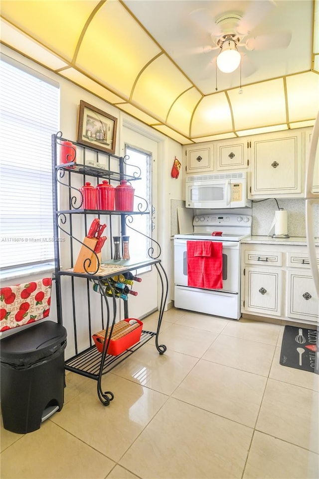 kitchen with ceiling fan, white appliances, backsplash, and light tile patterned floors