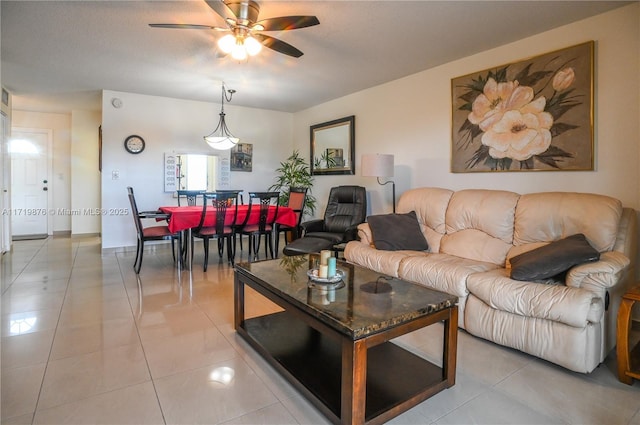 living room with ceiling fan and light tile patterned flooring