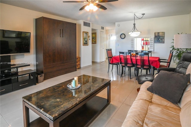 tiled living room featuring ceiling fan