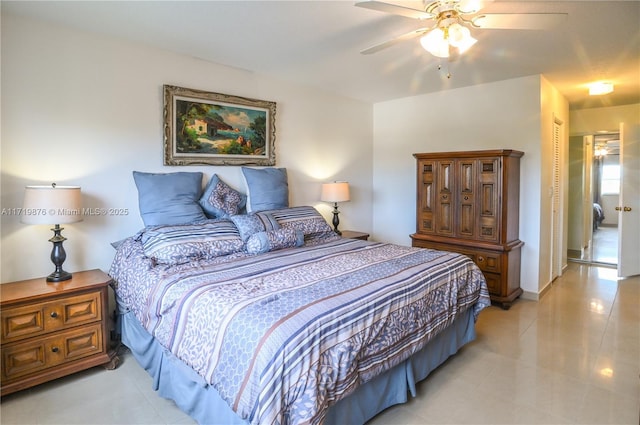 bedroom with light tile patterned floors, a closet, and ceiling fan