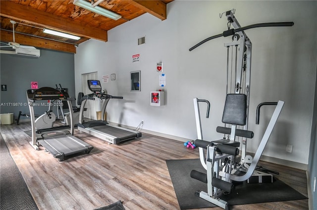 interior space featuring a wall mounted air conditioner, wood ceiling, and hardwood / wood-style flooring