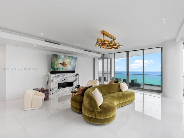 living room with a high end fireplace, light tile patterned flooring, and floor to ceiling windows