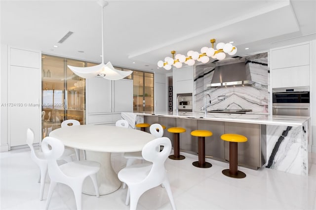 dining area with sink and light tile patterned flooring