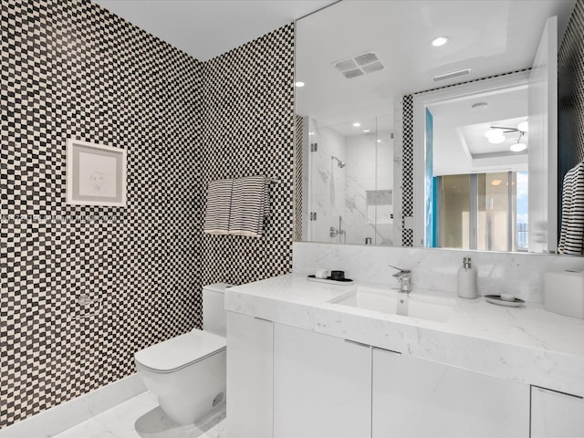 bathroom with toilet, a shower with shower door, and vanity