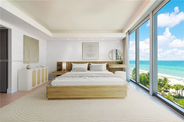 bedroom featuring a beach view, a wall of windows, multiple windows, and a water view