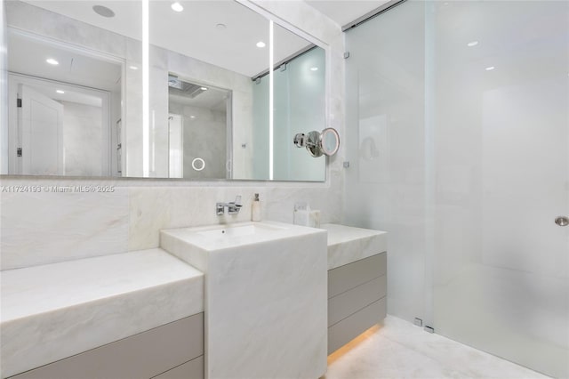 bathroom featuring vanity and a shower with shower door