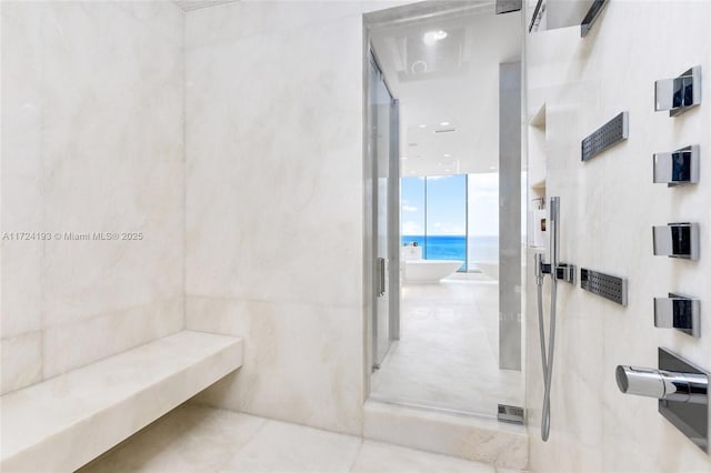 bathroom featuring independent shower and bath, a water view, and tile patterned flooring