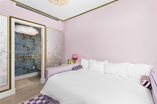 bedroom featuring light wood-type flooring and crown molding