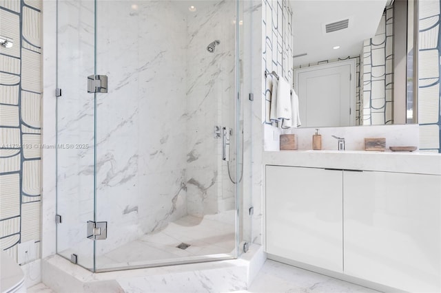 bathroom with an enclosed shower and vanity