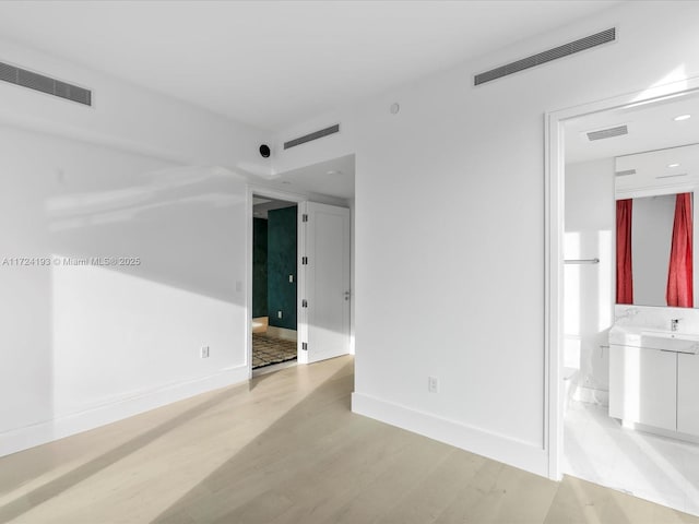 spare room featuring light hardwood / wood-style floors and sink