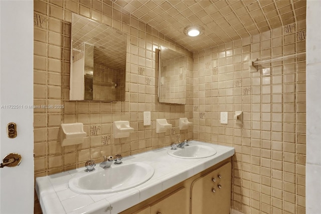 bathroom with vanity and tile walls