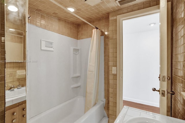 bathroom featuring shower / bath combo and vanity