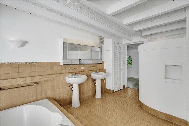 bathroom with beam ceiling, a bathtub, tile walls, and wooden ceiling