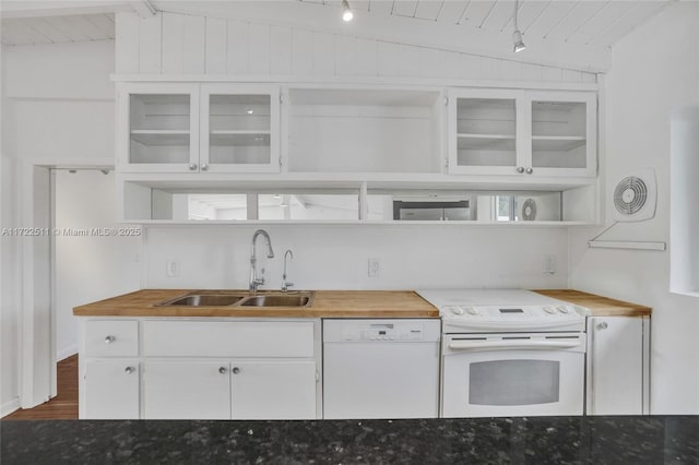 kitchen with butcher block counters, white appliances, lofted ceiling with beams, sink, and white cabinetry