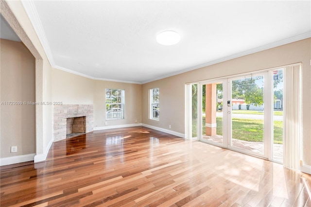 unfurnished living room with a fireplace, hardwood / wood-style floors, and ornamental molding