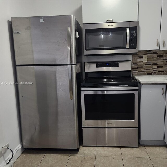 kitchen featuring dark brown cabinets, backsplash, stainless steel appliances, and sink