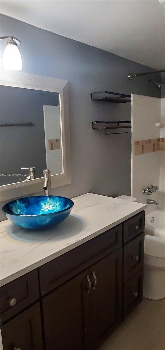 full bathroom featuring vanity, shower / bath combination, and toilet