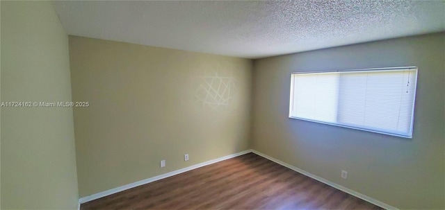 unfurnished room with wood-type flooring and a textured ceiling