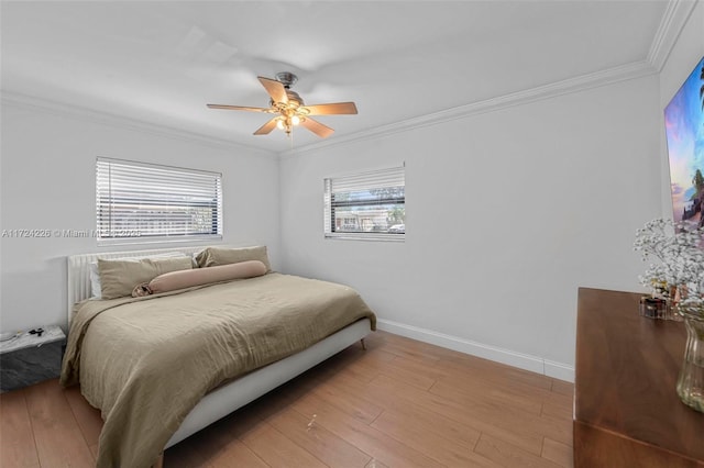 bedroom featuring ceiling fan, crown molding, and light hardwood / wood-style floors