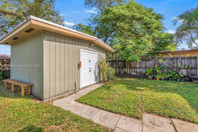 view of outbuilding featuring a yard